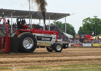 A tractor blows smoke at the Budweiser Dairyland Super National Truck and Tractor Pull