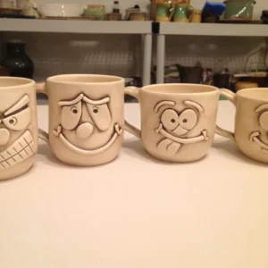 A row of four mugs with Googly eyes