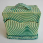 A green cube shaped trinket box