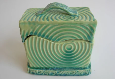 A green cube shaped trinket box