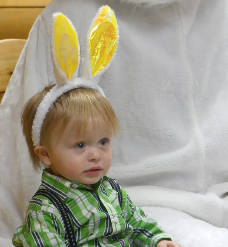 Boy wearing rabbit ears.