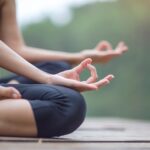 A person practicing yoga sitting crosslegged