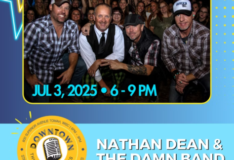 Nathan Dean and the Damn Band pose in front of a crowd.