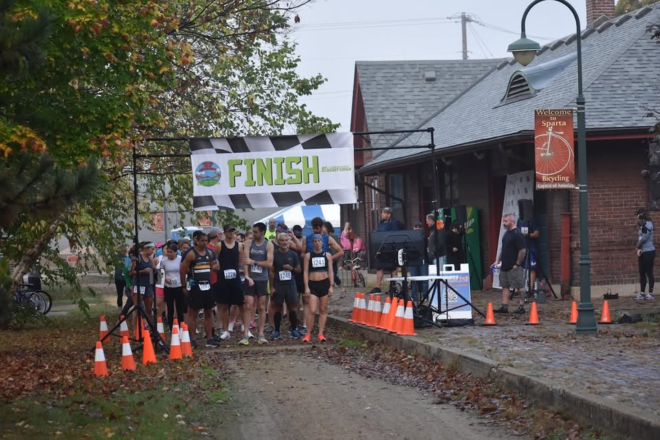 A group of runners get ready to start a race on the Elroy Sparta Bike Trail