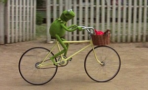 kermit the frog riding a bike
