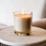 A small candle in a glass jar