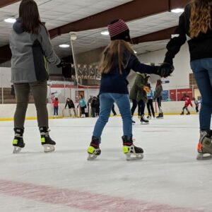 families skating at the ice rink