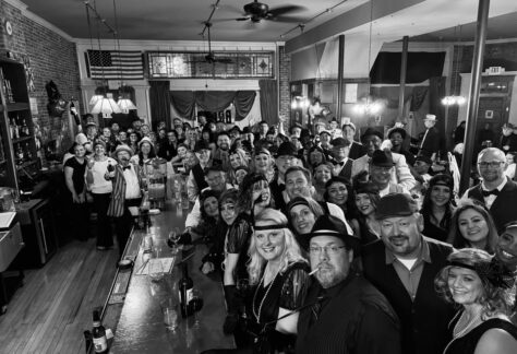 A photo of a bar full of 1950s dressed people