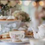 a pretty tea set and small cakes