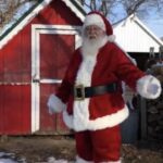 Santa Claus outside a red shed