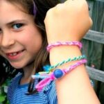 A girl showing off her friendship Bracelets.