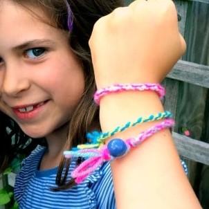 A girl showing off her friendship Bracelets.