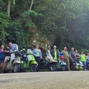 A line of scooters along a road in the driftless