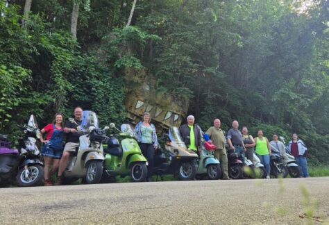 A line of scooters along a road in the driftless