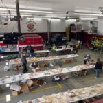 A overview picture of Cashton Fire and Responders holding boxes and setting tables.