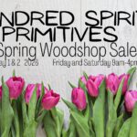 A poster with the event information on it, along with flowers.