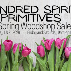 A poster with the event information on it, along with flowers.