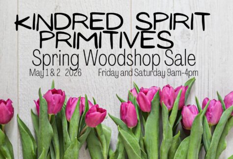 A poster with the event information on it, along with flowers.