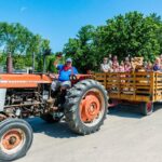 A group of people on a tractor pull.