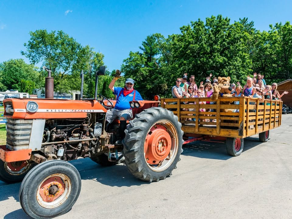 A group of people on a tractor pull.