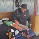 A picture of a man making BBQ.