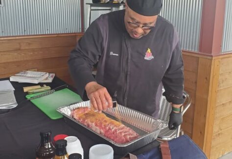A picture of a man making BBQ.