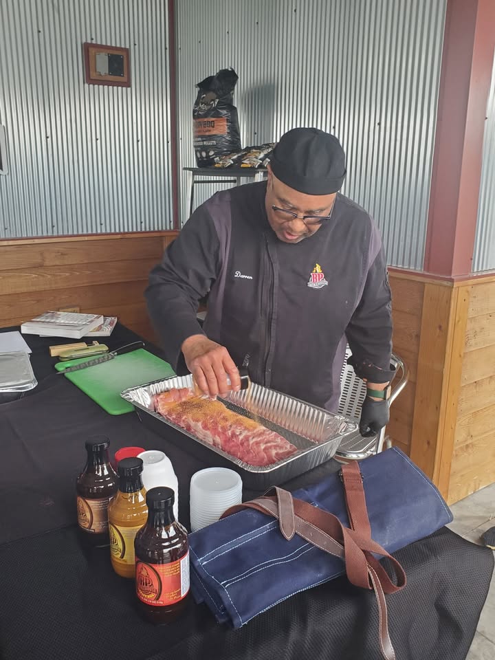 A picture of a man making BBQ.