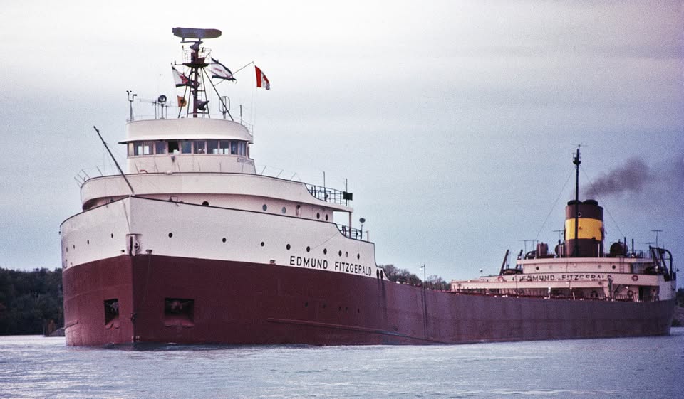 A picture of a ship in front of another boat on open water.