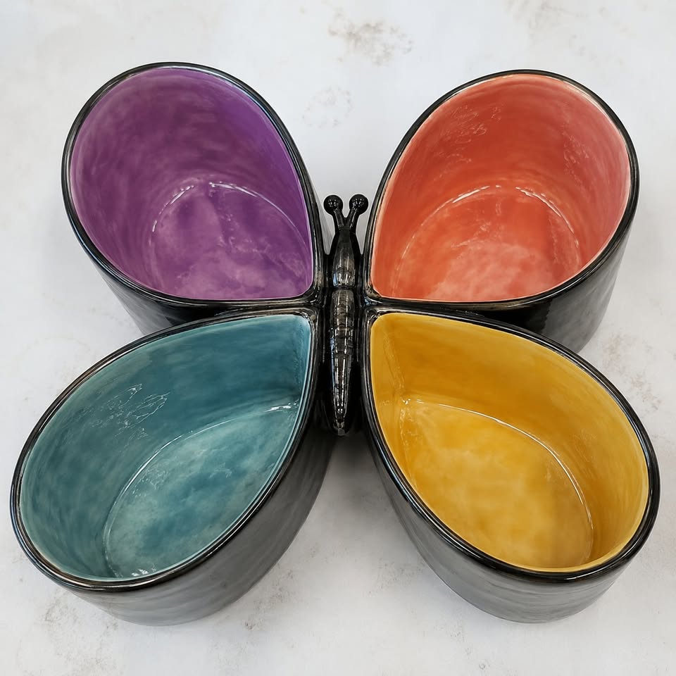 A multi colored serving dish shaped like a butterfly