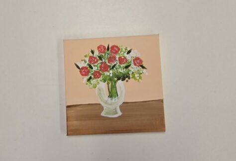 a canvas painting of a vase full of roses