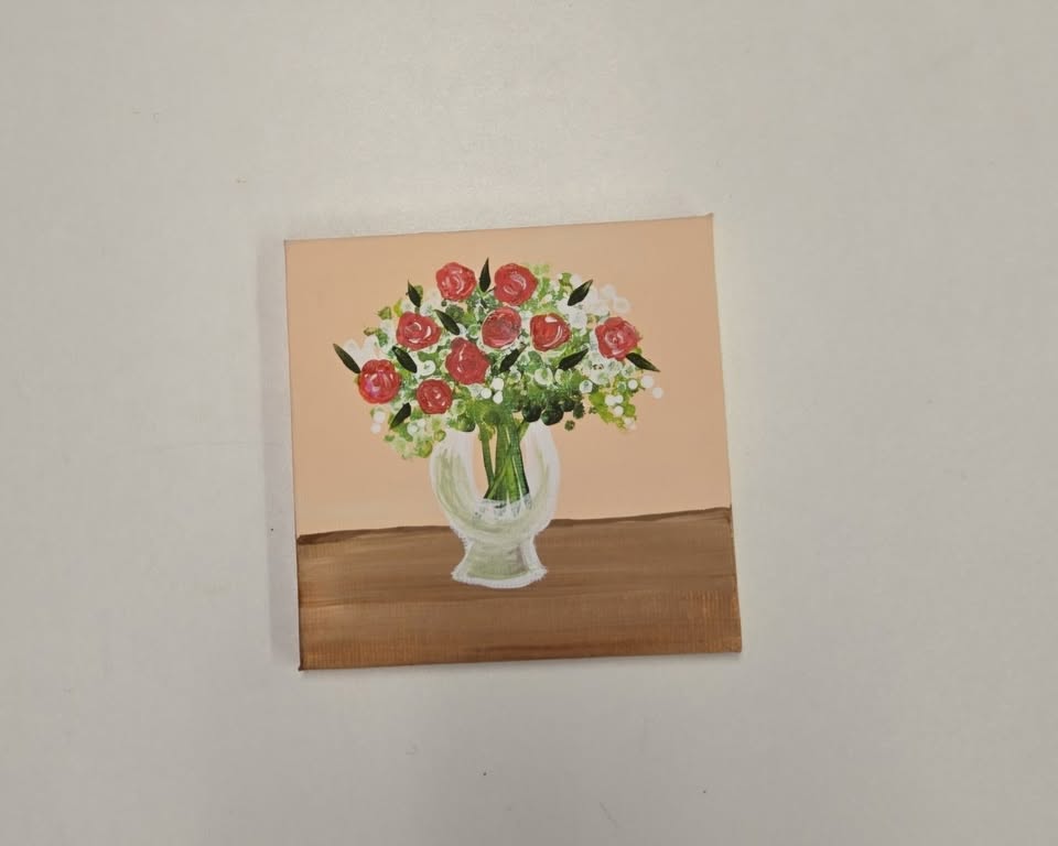 a canvas painting of a vase full of roses