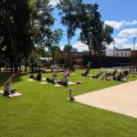a group of people enjoying yoga outside