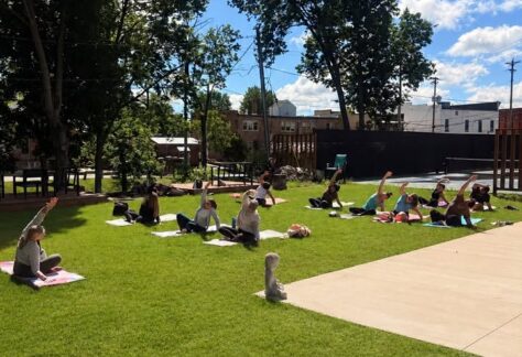 a group of people enjoying yoga outside