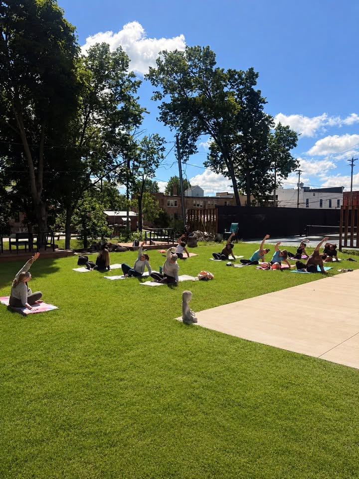 a group of people enjoying yoga outside