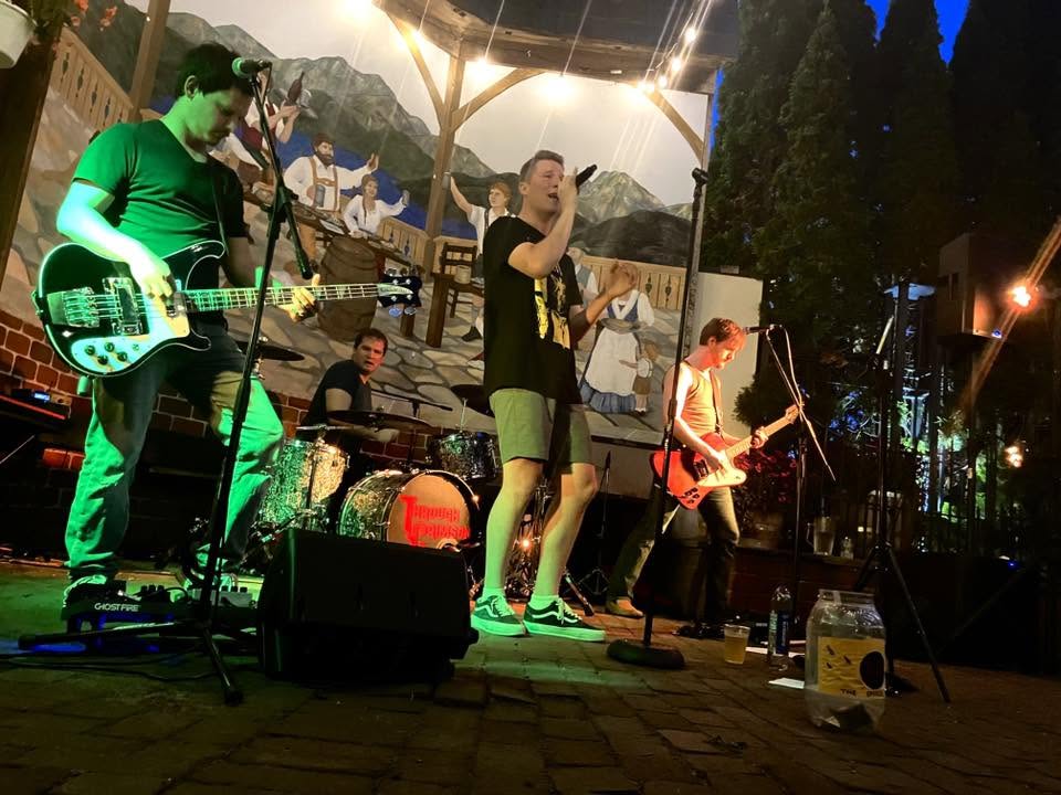 The band Through Crimson performing on stage