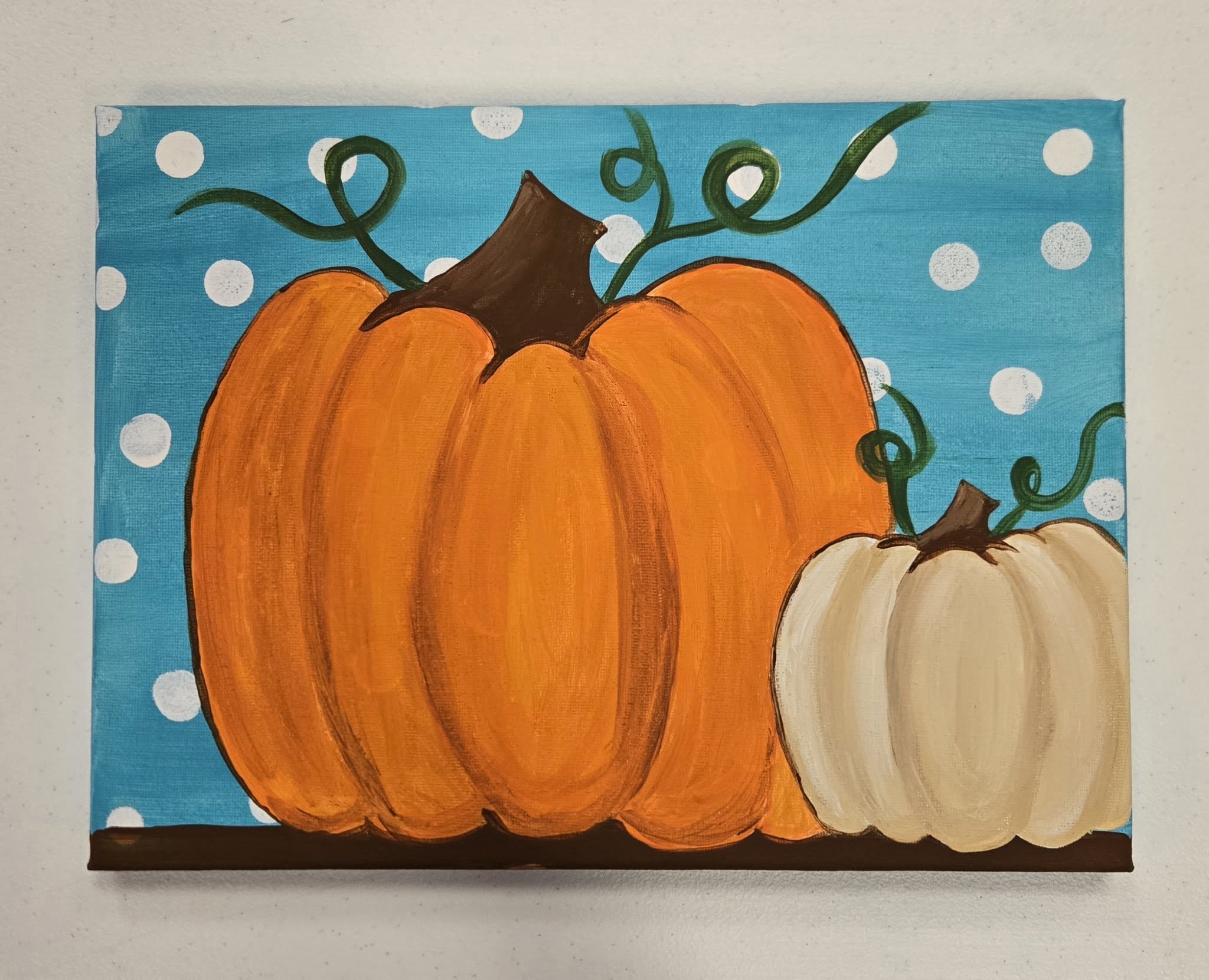 A canvas painting of a pumpkin