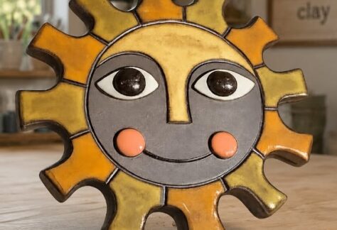 A pottery sun wall hanger