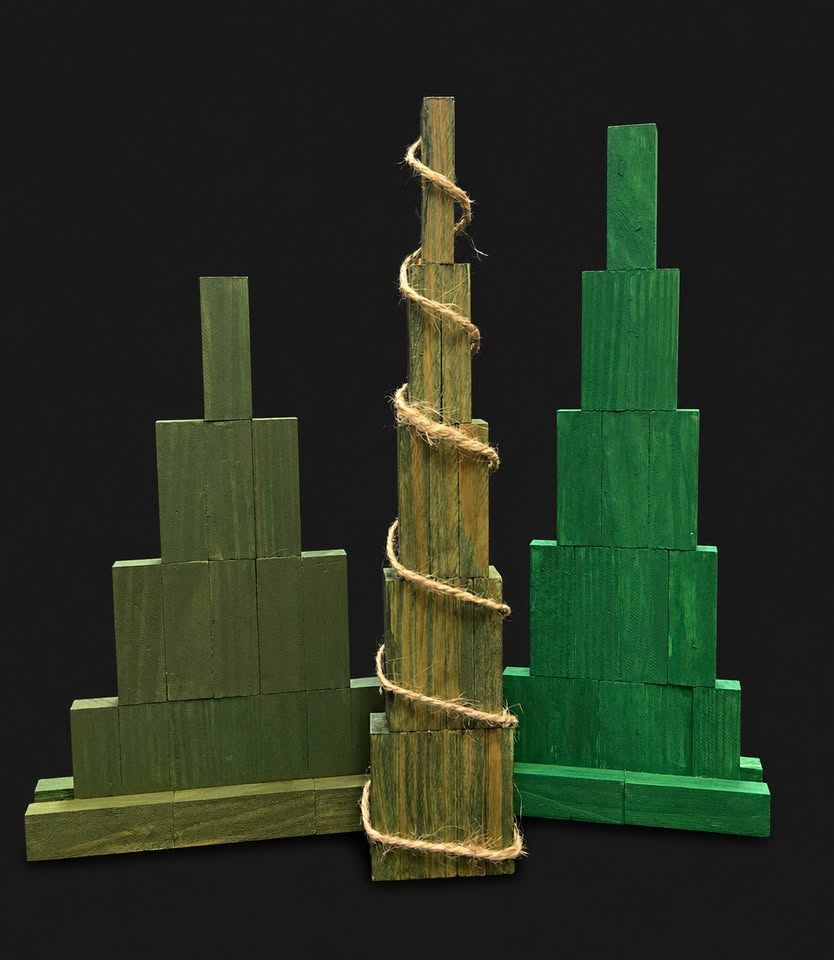 Three wooden trees made from blocks and painted