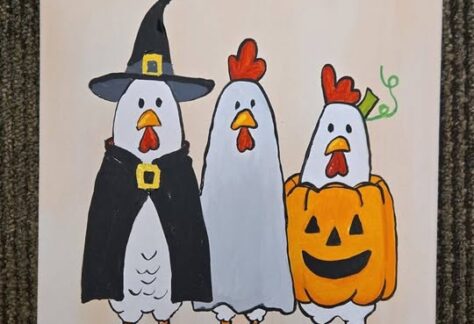 A canvas painting of three chickens in halloween costumes