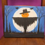 A canvas painting of a scarecrow in front of the full moon