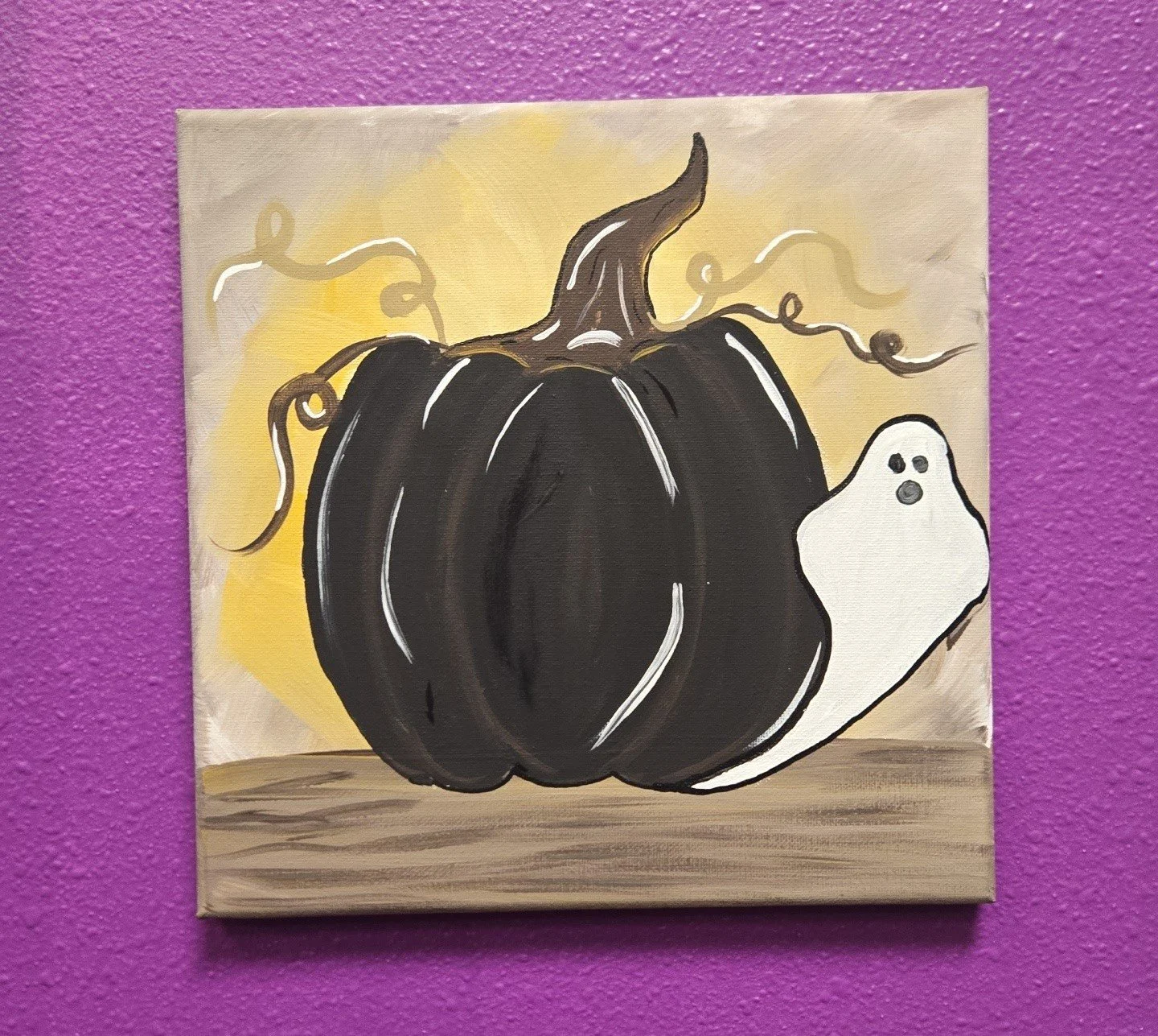 A ghost peeking out from behind a pumpkin